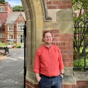 Picture of Sam Glenister-Batey, head of conferences and events at the University of Leeds. Stood outside the Great Hall Leeds
