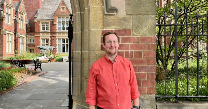 Picture of Sam Glenister-Batey, head of conferences and events at the University of Leeds. Stood outside the Great Hall Leeds