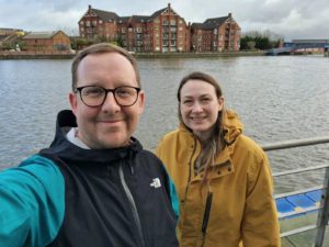 Sam Glenister-Batey, Head of Conferences and Events, and Karina Kendrick, Assistant Head of Conferences and Events, take a selfie in front of the river Lagan in Belfast