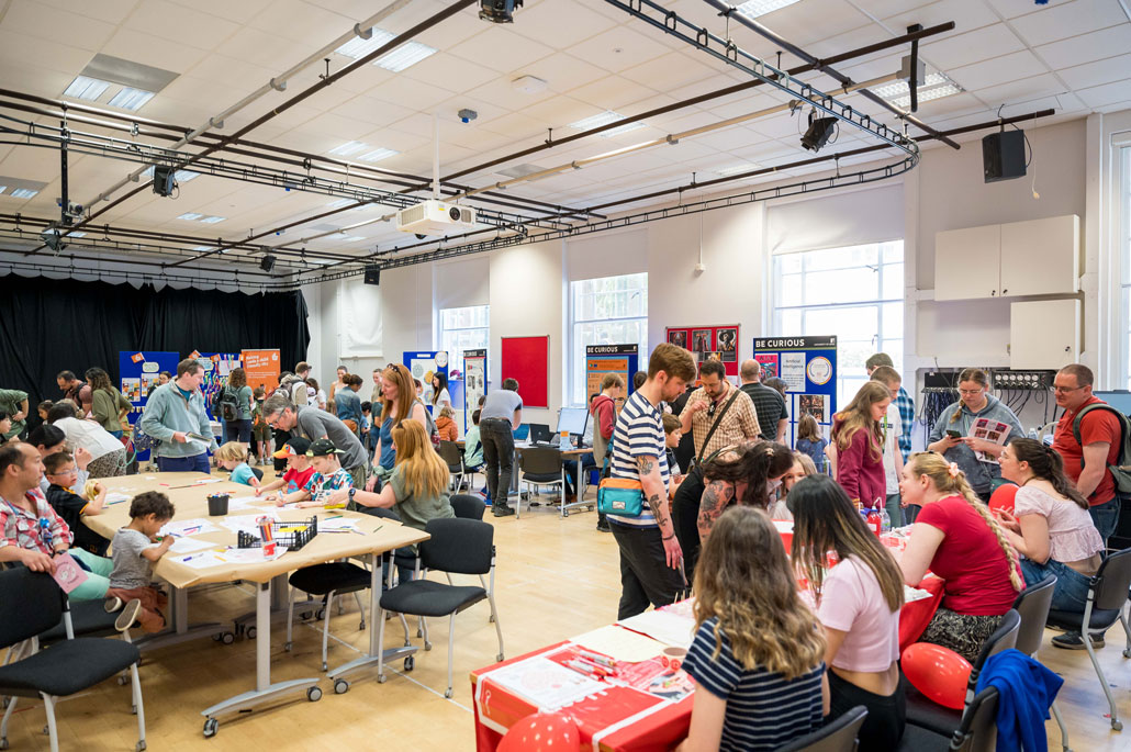 Session at the Be Curious event. People engaging with stalls 