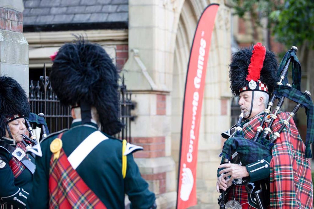 Three people playing bagpipes