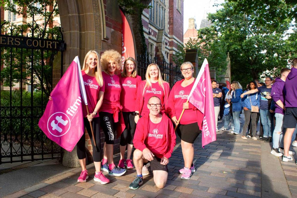 Team dressed in pink pose for a photograph