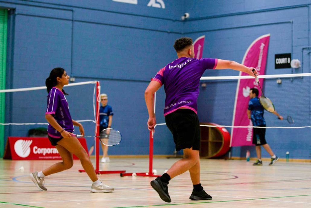 Two badminton players in action in a doubles game