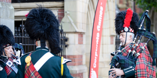 People playing bagpipes at an outdoor event